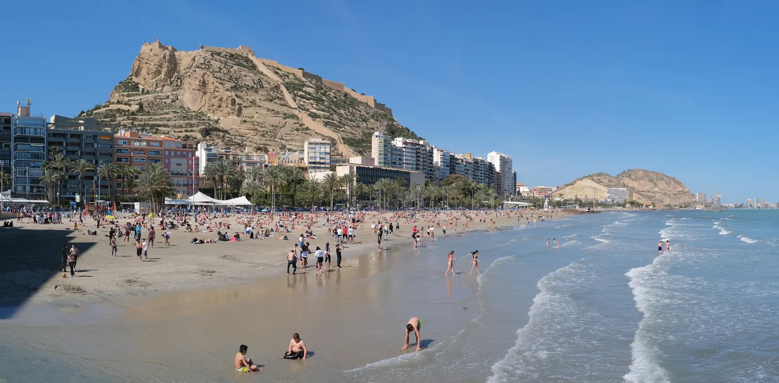 Piaszczysta plaża Postiguet w Alicante ze wzgórzem zamkowym w tle
